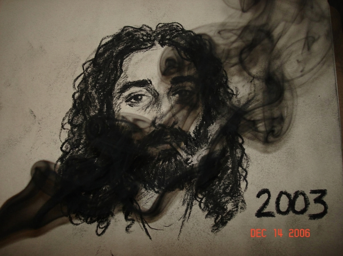 a jagged, rough charcoal drawing of a man's face, partially obscured by thick black smoke. on the charcoal in the bottom right corner, the number '2003' is written in blocky black ink.