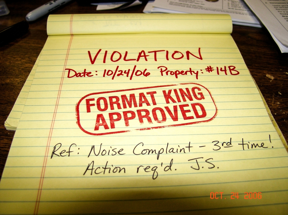 a close up photo of a yellow legal pad with 'VIOLATION' written in red ink and a stamp that says 'FORMAT KING APPROVED'