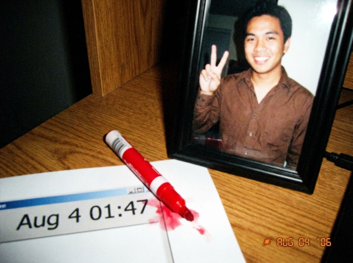 A close-up of a wooden desk shrine with a framed Gabriel Chantayan print, next to a red marker lying diagonally across a screenshot of the Aug 4 01:47 timestamp, the marker tip touching the timestamp area causing visible bleed-through