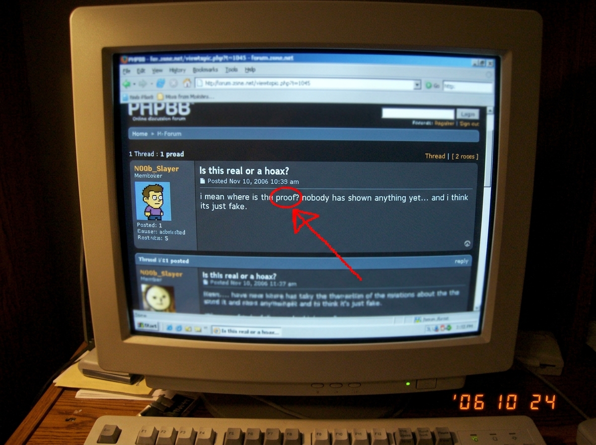 A close-up photo of a forum post on a CRT monitor, highlighting the word 'proof' with a red arrow drawn in MS Paint