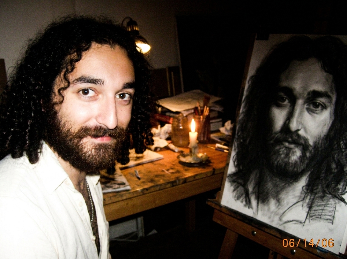 A small candle flickering alone on a messy wooden studio table, the flame barely visible in the dark room, casting a small ring of light on the surface, a charcoal drawing of Gabriel's face partially visible in the shadows