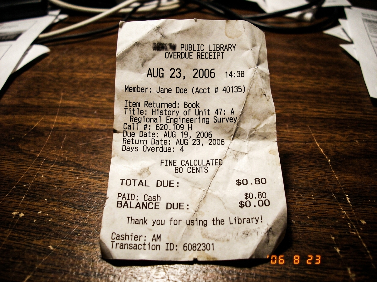A crumpled library overdue receipt for 80 cents, dated August 23, 2006. The paper is creased and the ink is slightly smudged. It lists a returned book titled 'History of Unit 47: A Regional Engineering Survey' with a due date of Aug 19 and a return date of Aug 23.