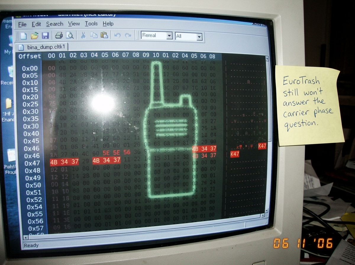 A screenshot of a hex editor showing a binary dump with 'K47' at offset 0x47, highlighted in red. Next to it, a sticky note with handwritten text: 'EuroTrash still won't answer the carrier phase question.' A green-glowing walkie-talkie shape is faintly visible in the background of the binary data as