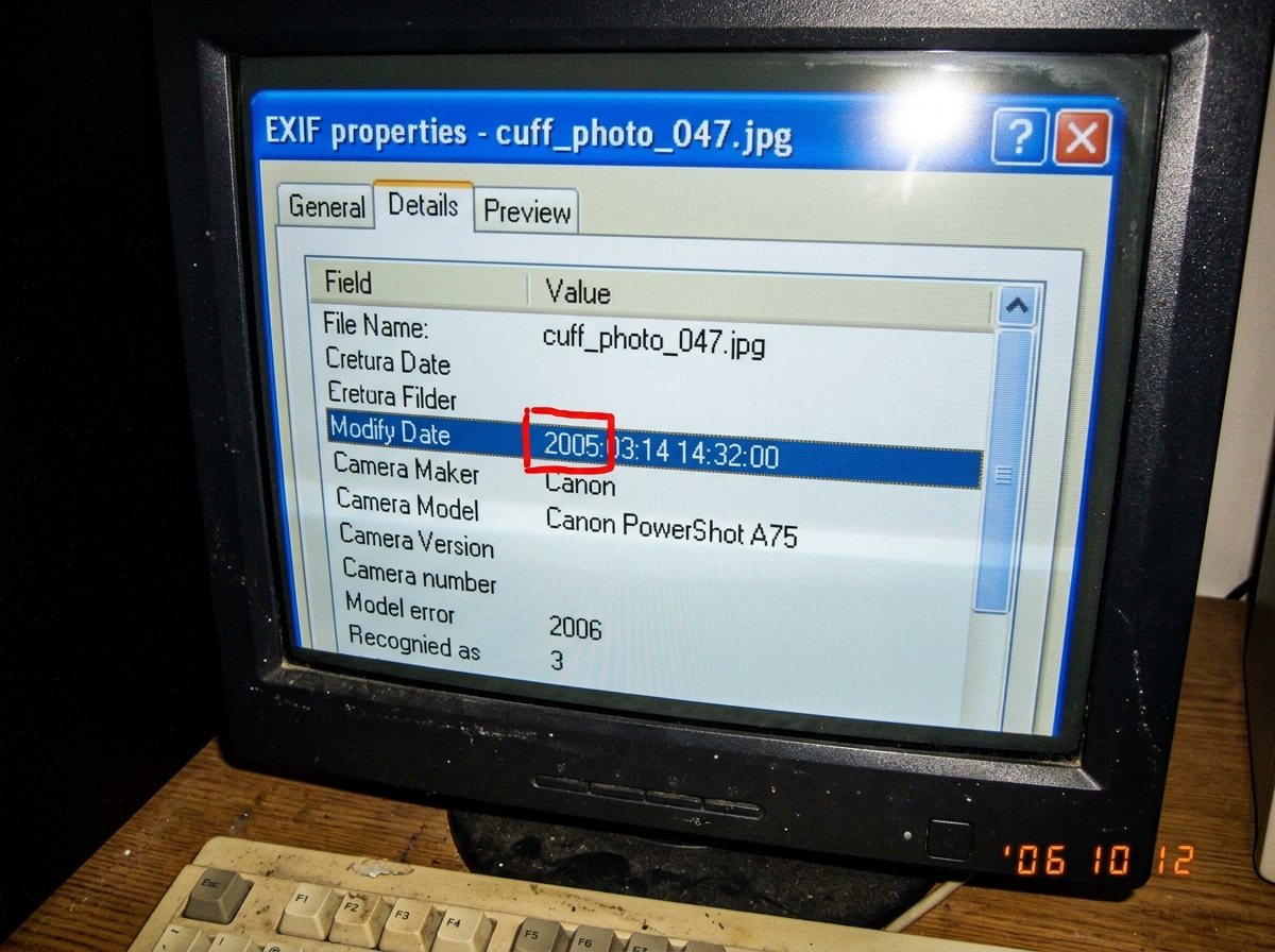 A screenshot of EXIF metadata displayed in a small utility window on Windows XP. The file name is 'cuff_photo_047.jpg'. The firmware date line reads '2005:03:14 14:32:00' highlighted with a red box around the year 2005. Below it, the model field shows 'Canon PowerShot A75'.