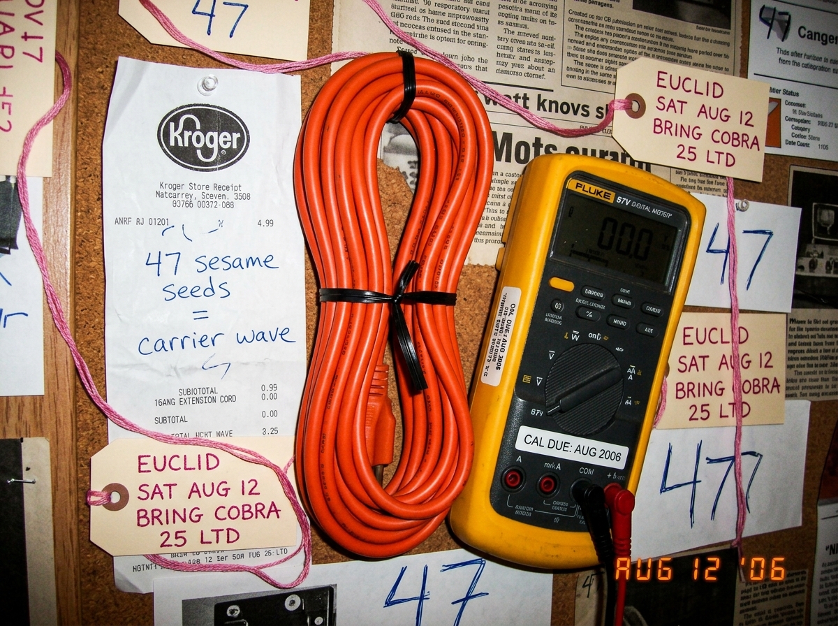 Fan shrine collage: crumpled Kroger cheese receipt annotating '47 sesame seeds = carrier wave', 16AWG extension cord coiled and ready, Fluke 87V with 'CAL DUE: AUG 2006' sticker, pink embroidery thread notes reading 'EUCLID SAT AUG 12 BRING COBRA 25 LTD' scattered with 47s everywhere
