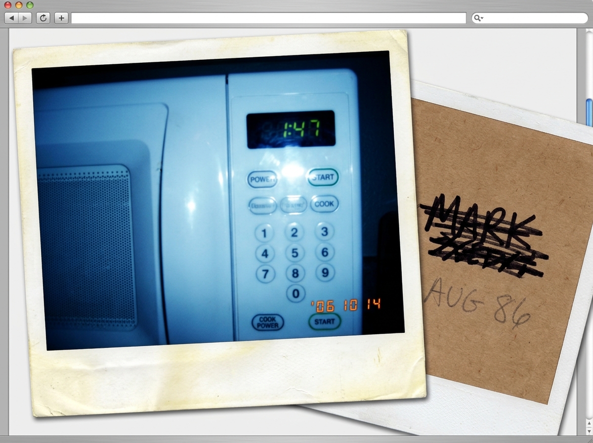A Polaroid photo showing a microwave clock displaying 1:47, with a blue tint over the image. The photo is slightly faded and has a white border. The back of the Polaroid is visible in the foreground, showing a name crossed out with black marker and the text 'AUG 86' written in pencil.