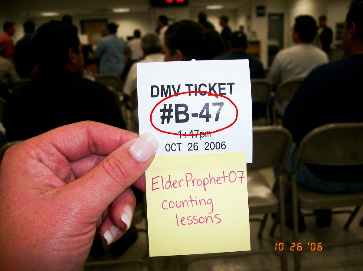 a photo of a DMV queue ticket #B-47, timestamp 1:47pm, held in someone's hand with a salon manicure visible, overlaid with a red circle around the ticket number and a handwritten note that says 'ElderProphet07 counting lessons' in pink ink on a sticky note