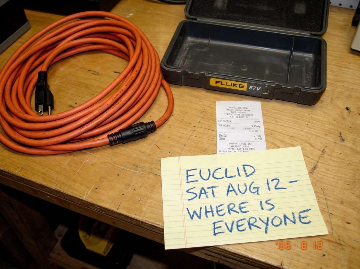 A photo of a coiled 16awg extension cord sitting beside an empty Fluke 87V case, a cheese receipt with '3 zloty' visible, and a crayon note that says 'EUCLID SAT AUG 12 - WHERE IS EVERYONE'