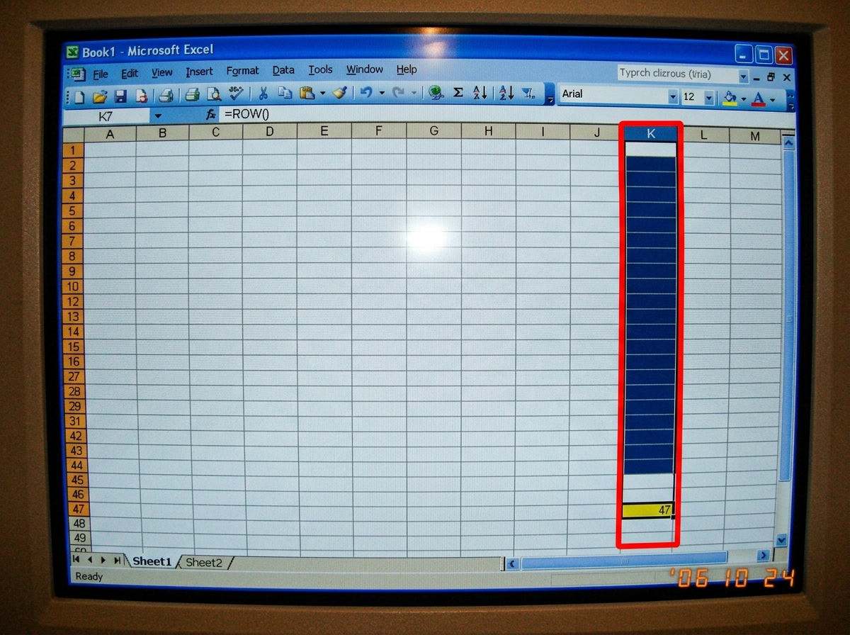 A screenshot of an Excel spreadsheet with column K selected, the formula bar reading '=ROW()' with the result '47' highlighted in yellow. The cell is empty below, with a red border around the entire K column. The sheet tab at the bottom says 'Sheet1' but there's a faint outline of a tab that looks l