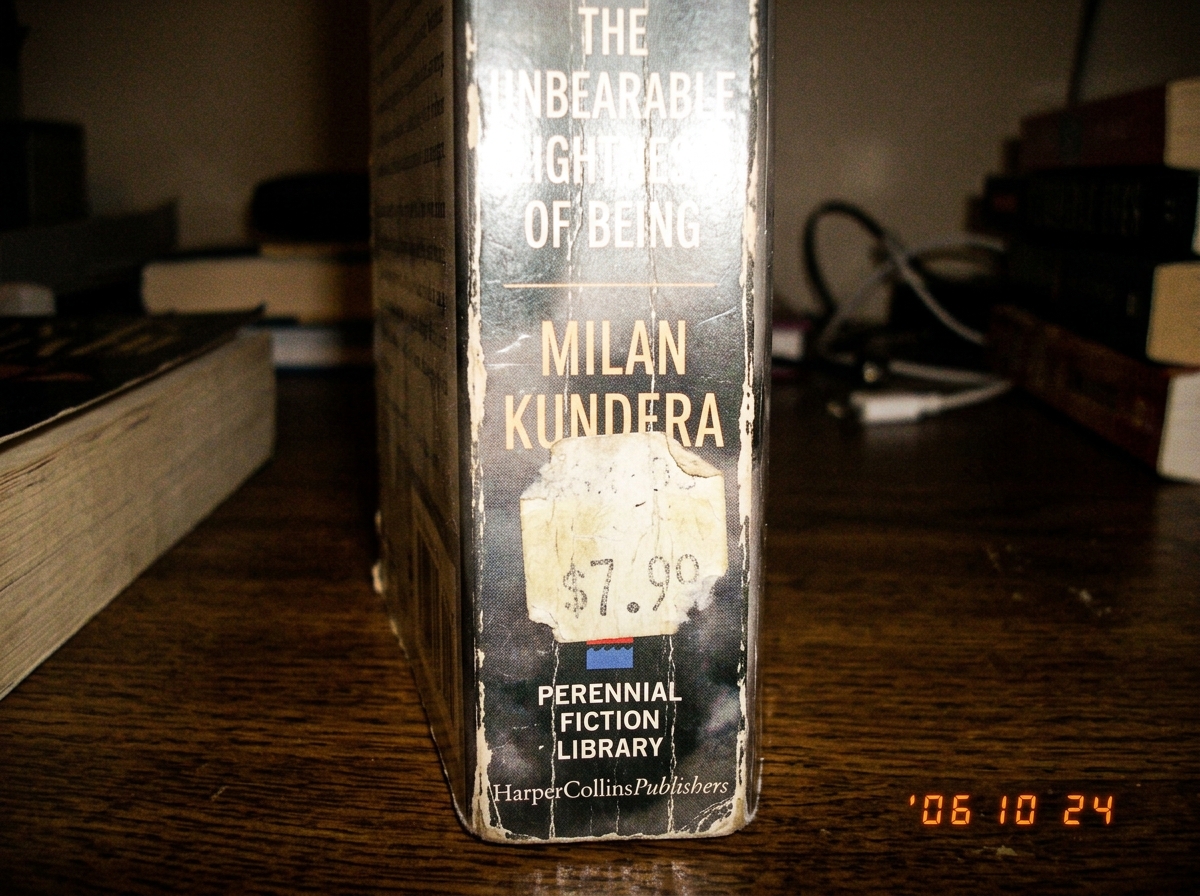 close-up of a paperback book spine with a faded price sticker and the publisher information