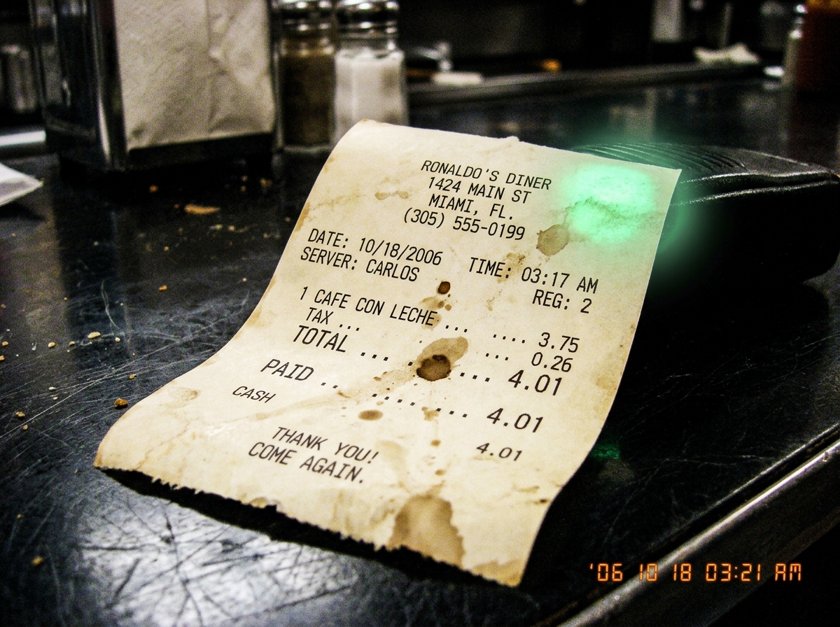 A thermal paper receipt from Ronaldo's Diner showing purchase of 'cafe con leche' at 3:17 AM. In the corner there is a faint green smudge - the walkie talkie glow pressed against the counter while Carlos waited. The receipt is curled at the edges and stained with coffee.