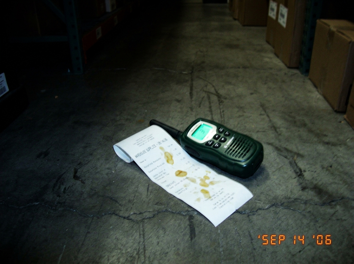 Thermal paper photo showing green glow walkie talkie device with mustard-stained receipt on warehouse floor at night