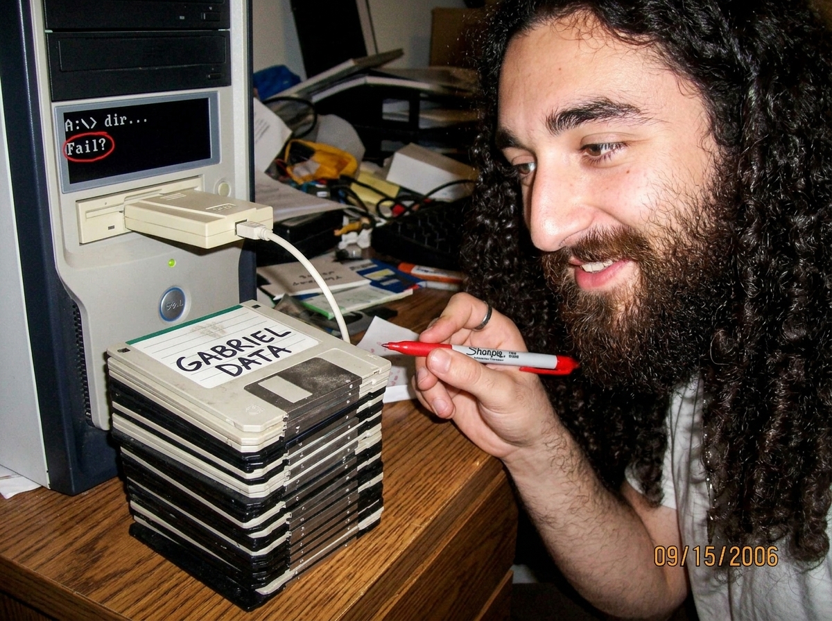 A stack of 47 floppy disks on a wooden desk, some sleeves slightly warped, labels handwritten in black sharpie reading 'GABRIEL DATA'. A 2006-era USB floppy drive is plugged into a beige desktop tower, with a command prompt window open showing 'A:\> dir' and the response 'Not ready reading drive A A