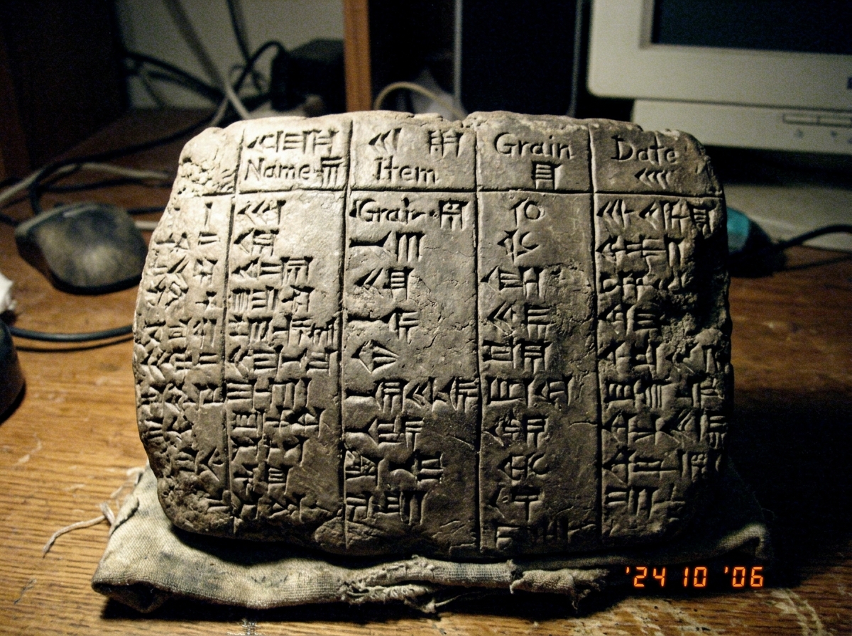 a clay tablet with cuneiform script that looks suspiciously like spreadsheet columns
