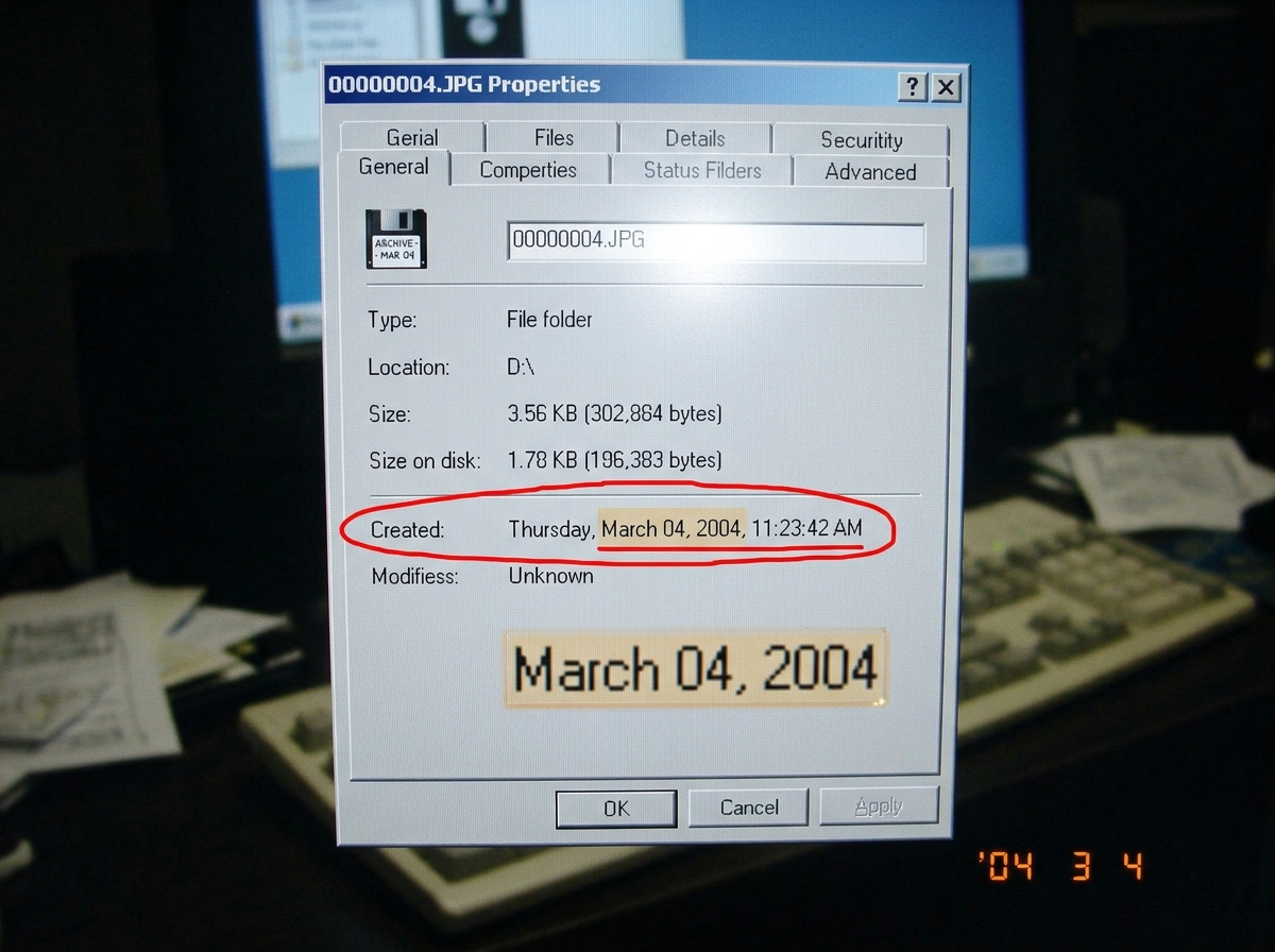 Close-up screenshot of a floppy disk photo's EXIF/properties window showing a date stamp of MARCH 04, with a red circle around the date. The photo metadata shows 'March 2004' clearly highlighted.