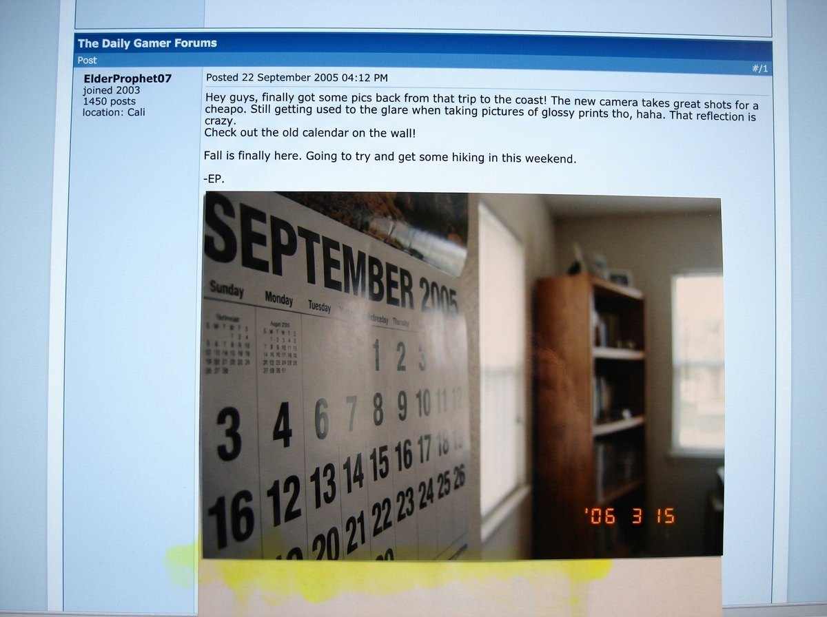 A screenshot of a forum post by ElderProphet07, with a 2005 wall calendar visibly reflected in the glossy photo paper, plus the edge of a yellow highlighter bleeding through from the other side of the page. The image is cropped to show the calendar month clearly reads September 2005.