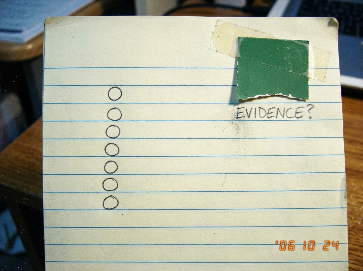A blank lined notebook page with six empty bullet points and a single green paint chip glued to the corner, labeled 'EVIDENCE?' in pencil.
