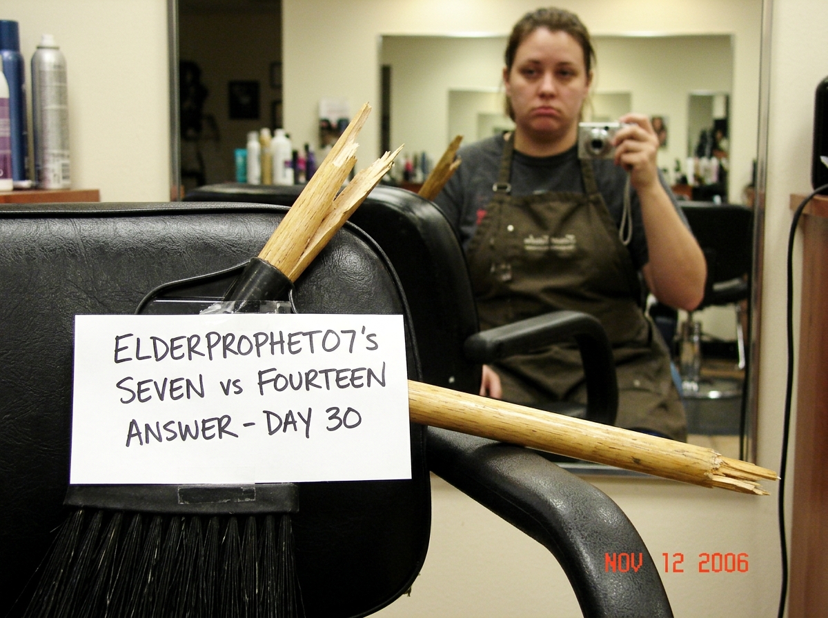 A handheld salon broom with a broken handle, propped against a salon chair with a sign taped to it that reads 'ELDERPROPHET07'S SEVEN vs FOURTEEN ANSWER - DAY 30' in marker. The background shows a salon mirror reflecting the photographer - a woman in a salon apron, expression flat and tired.