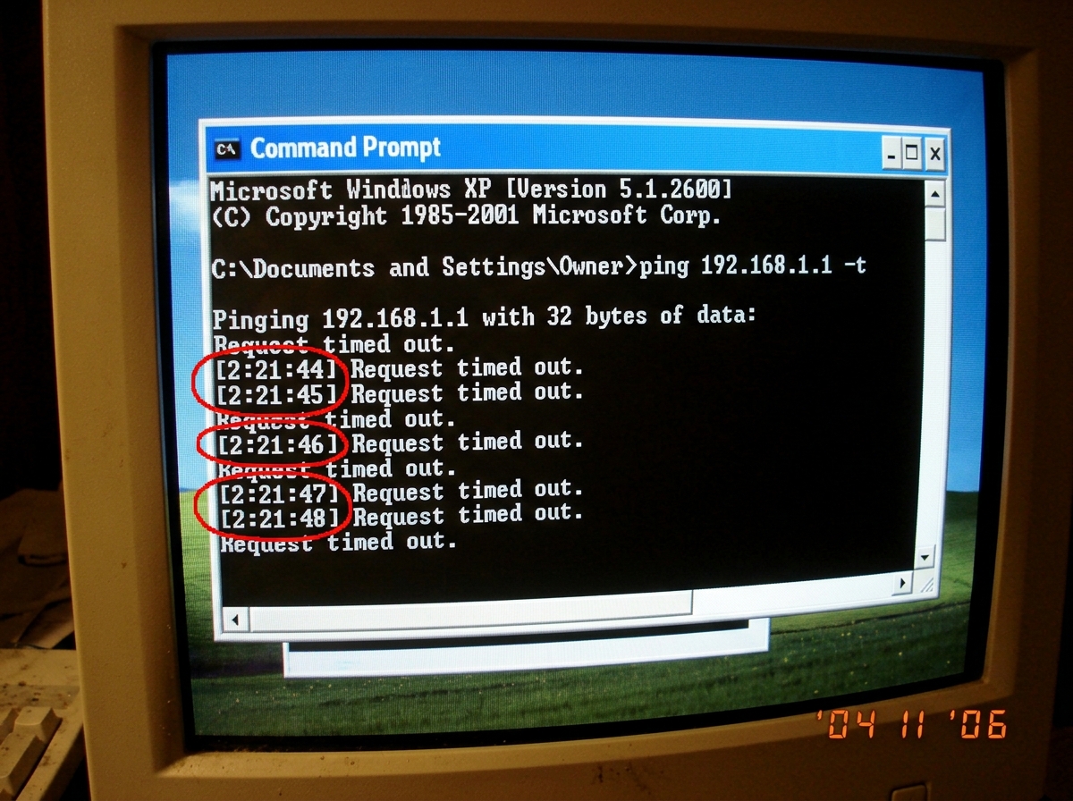 screenshot of a Windows XP command prompt window showing a ping test with 'Request timed out' messages, timestamp visible as 2:21:44, with red circles drawn around the timestamps in MS Paint