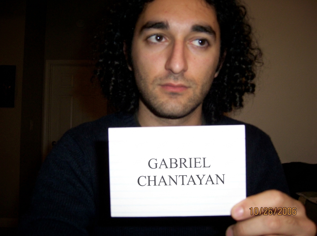 A close-up photograph of a white index card with the name GABRIEL CHANTAYAN typed in perfect Times New Roman, centered.