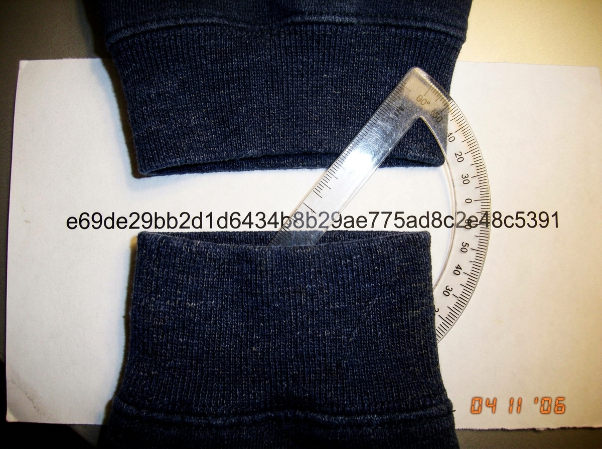 A close-up of the dark blue woven cuff from ClassOf04_Truther's attachment, now laid over a printed SHA1 hash output (e69de29bb2d1d6434b8b29ae775ad8c2e48c5391) with a clear plastic protractor overlaying the weave pattern at 47 degrees.