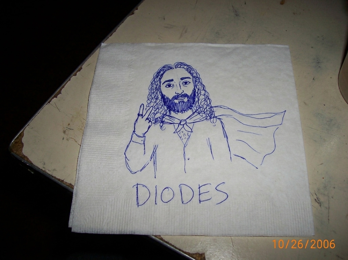 A doodle on a paper towel of Gabriel Chantayan in a superhero cape, drawn in ballpoint pen with the word 'DIODES' written underneath in shaky handwriting