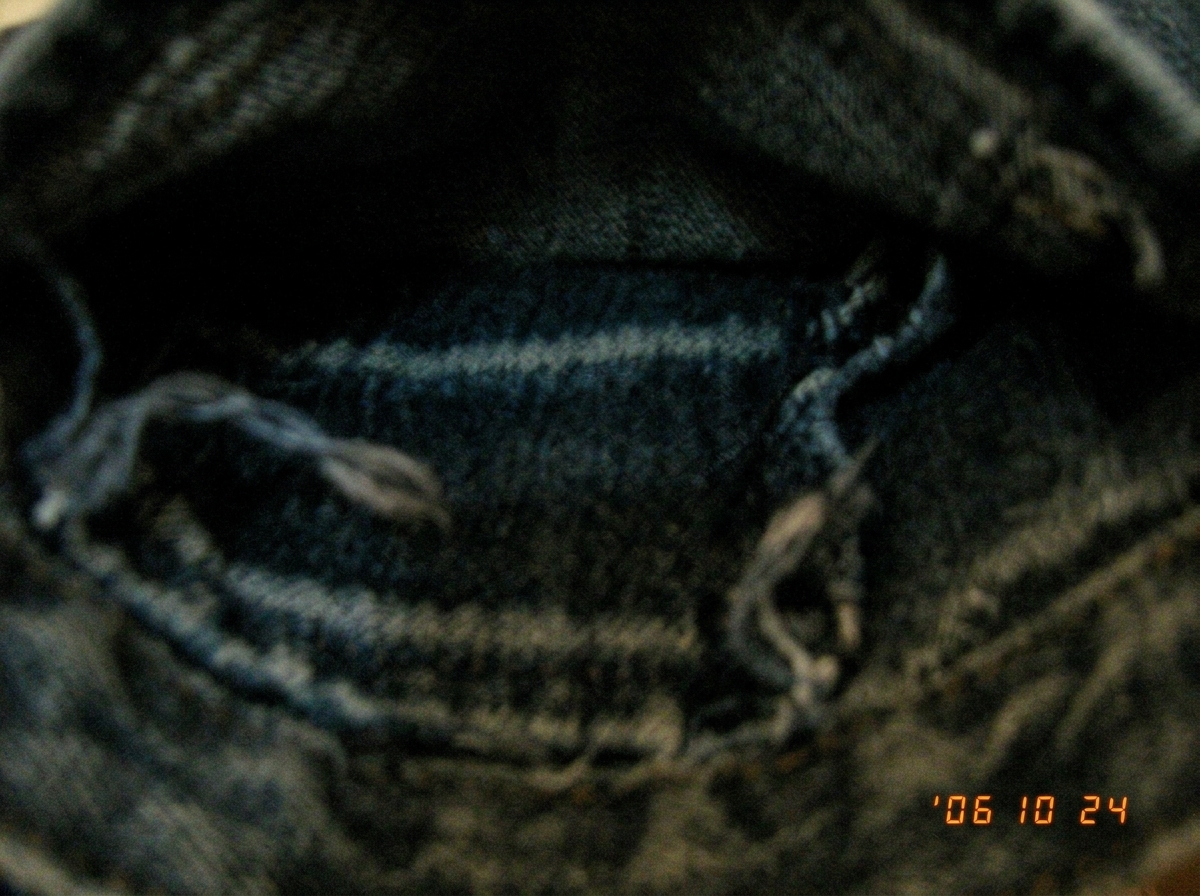 A blurry, dark photo taken from inside a pocket - just a few threads of fabric visible, no discernible content. The photo is titled 'target stakeout prep' but shows nothing useful.